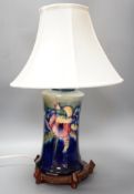 A Moorcroft orchid pattern lamp base with shade and later stand 30cm