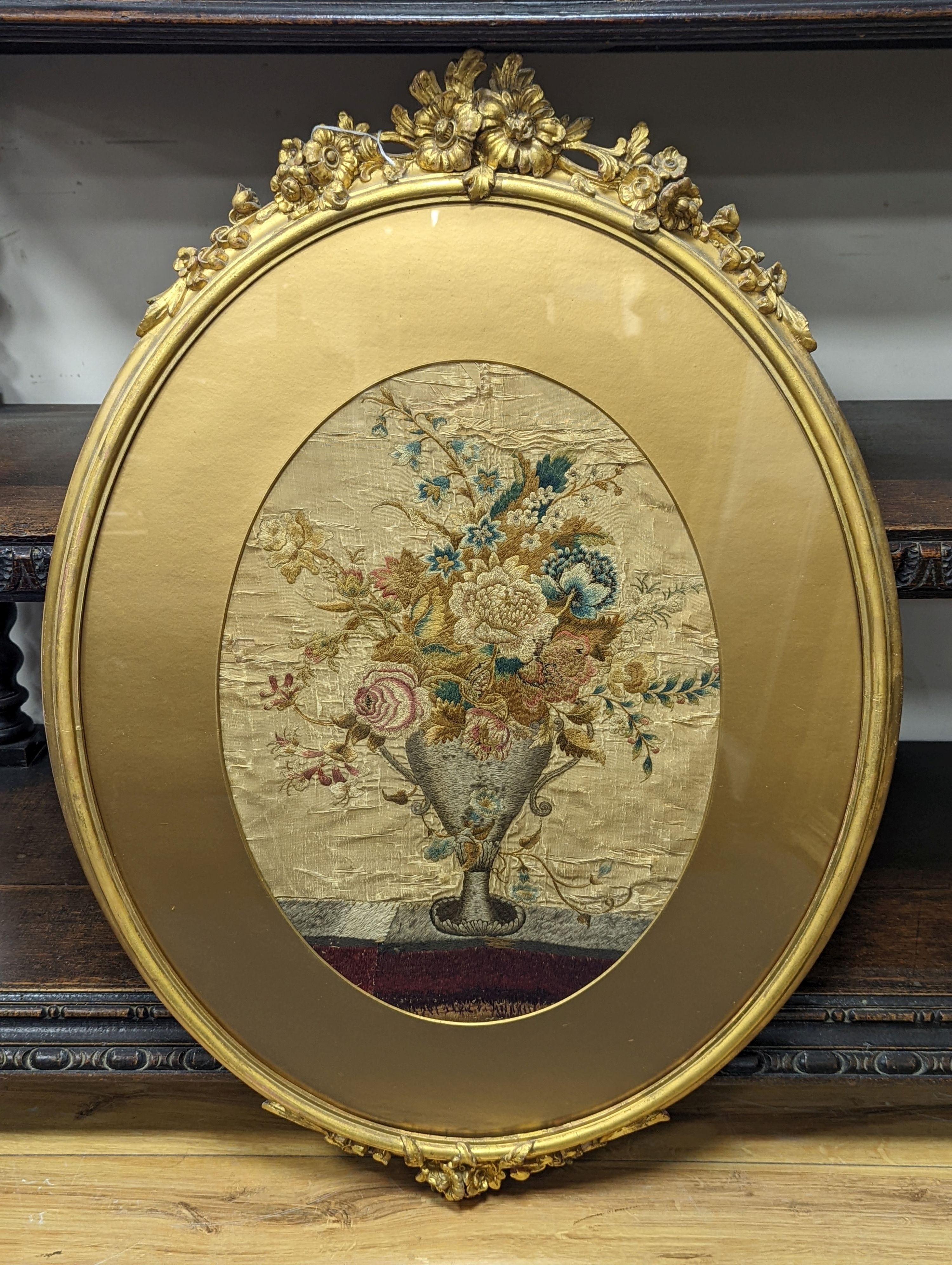 A Georgian oval silk embroidery panel depicting a two handled classical urn containing mixed flowers - Image 2 of 3