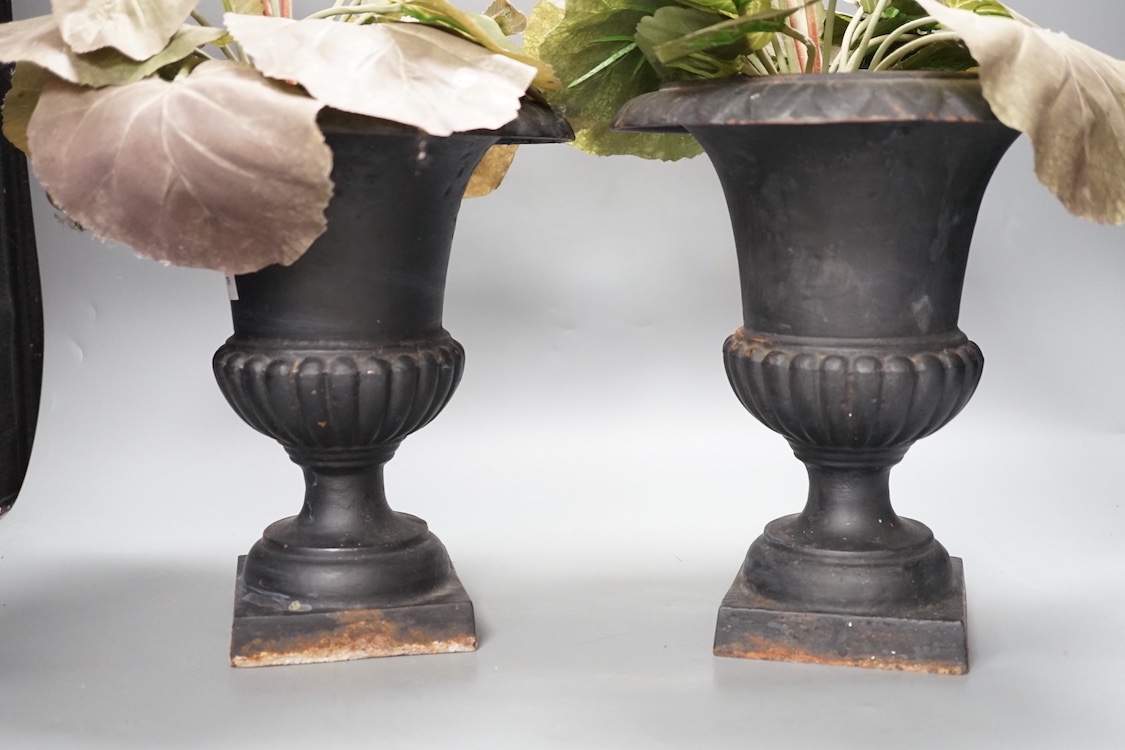 A pair of cast iron urns 25cm, containing faux plants - Image 3 of 3