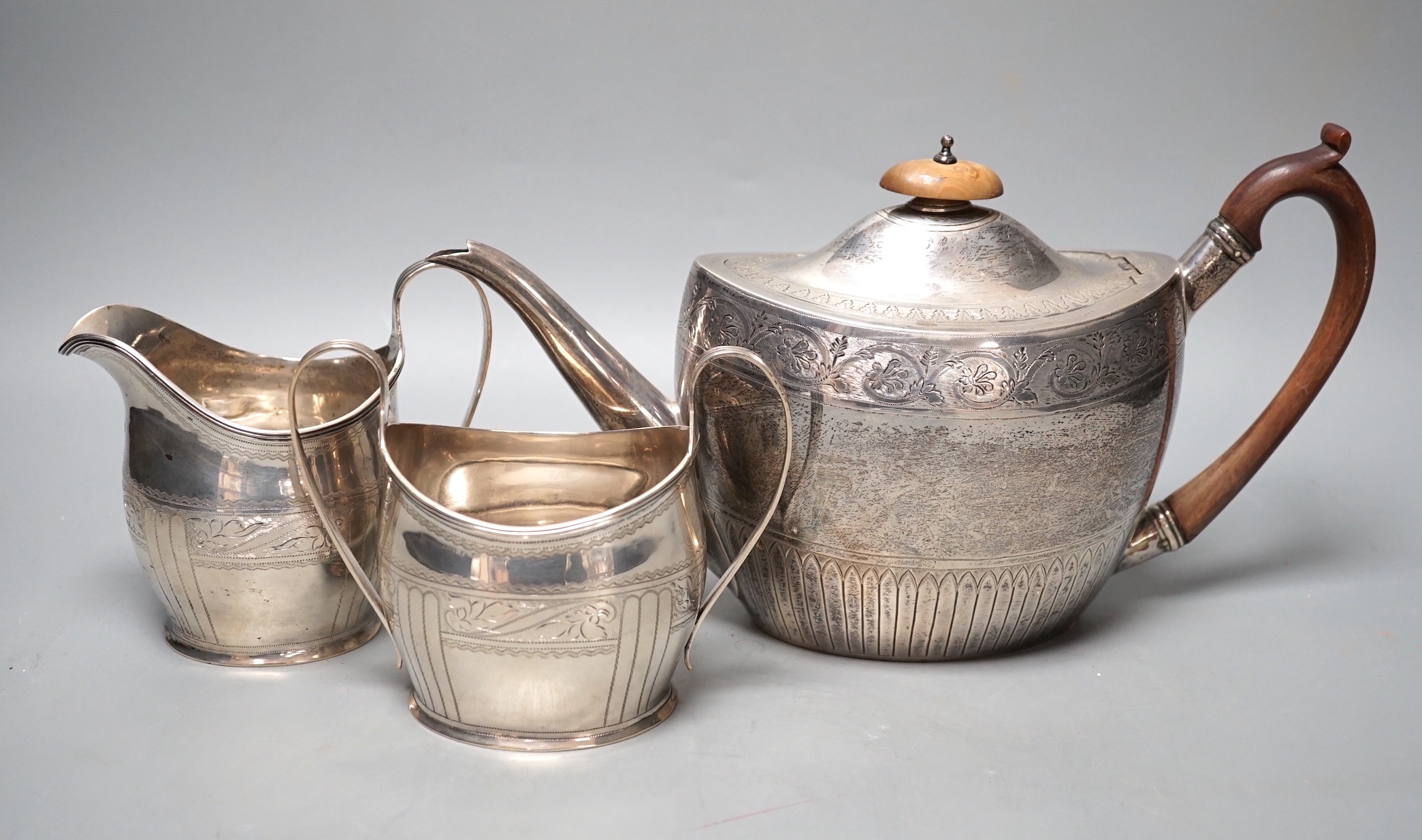 A 1930's engraved silver oval three piece tea set, S. Blanckensee & Sons Ltd, Chester, 1936/7, gross