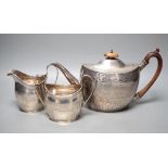 A 1930's engraved silver oval three piece tea set, S. Blanckensee & Sons Ltd, Chester, 1936/7, gross