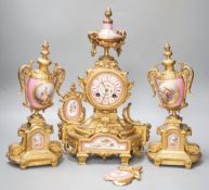 A French gilt metal and porcelain clock garniture. 36.5cm