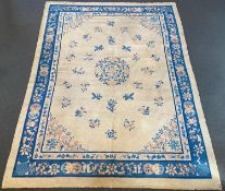 A Chinese ivory ground carpet with scattered floral field 368 x 284 cms