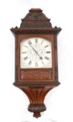 A large and impressive early 20th century carved mahogany cased wall clock, the triple fusee