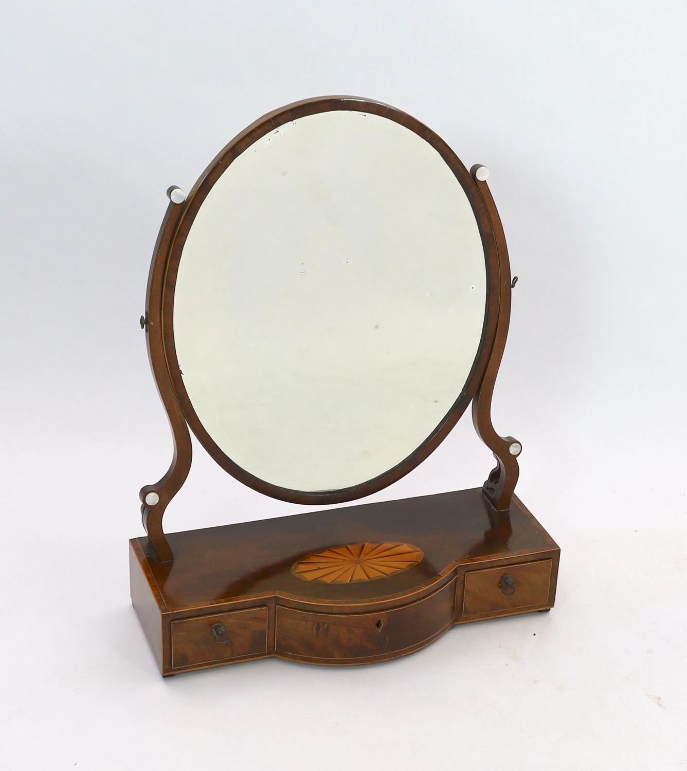 A George III mahogany satinwood paterae inlaid bowfront toilet mirror, width 57cm depth 24cm