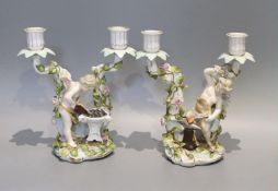 A pair of early 20th century German porcelain two branch candelabra, emblematic of industry,