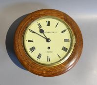 A late Victorian oak cased single fusee wall dial, marked Shoolbred & Co, London, dial 20cm