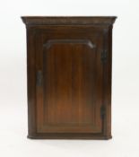 A George III oak hanging corner cupboard, width 75cm depth 43cm height 99cm