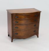 A reproduction George III design mahogany serpentine chest, with brushing slide, width 92cm depth