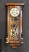 A late 19th century part ebonized walnut Vienna type wall clock, circular dial with subsidiary