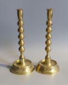 A pair of Victorian brass ejector candlesticks, with bobbin stems, height 31cm