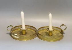 A pair of 19th century circular brass chambersticks, diameter 18cm