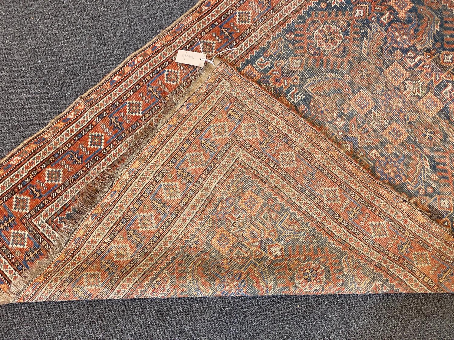 A Shiraz blue ground rug with dense floral field (worn), 144 x 102 cms - Image 4 of 4