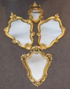 A pair of George III style giltwood cartouche wall mirrors, height 60cm, together with two similar