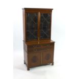 An Edwardian satinwood banded mahogany bookcase cupboard, fitted three drawers, width 91cm depth