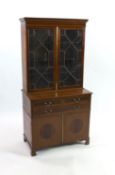 An Edwardian satinwood banded mahogany bookcase cupboard, fitted three drawers, width 91cm depth