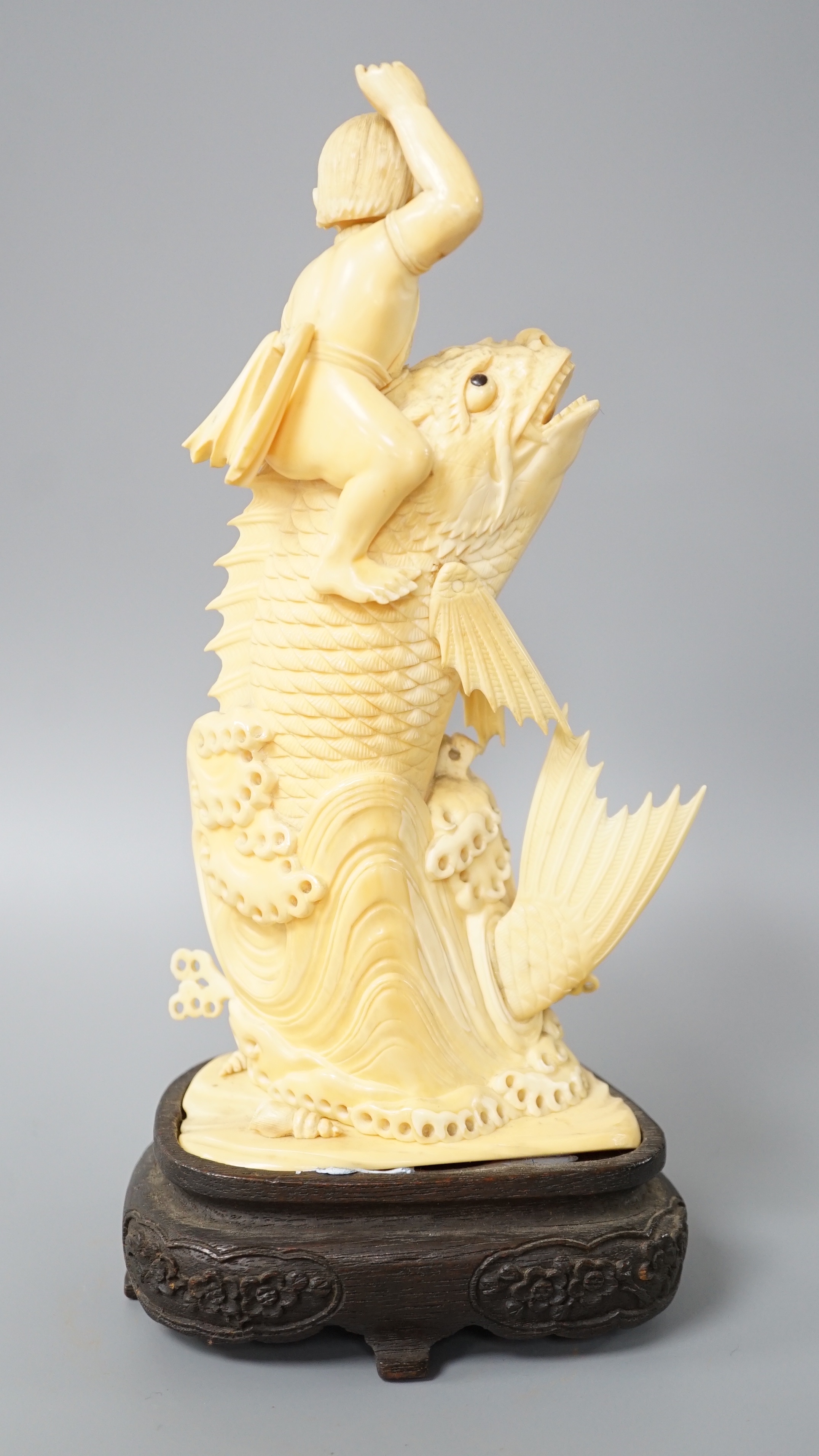 A Japanese sectional ivory okimono of a boy riding a leaping carp, early 20th century, wood stand, - Image 3 of 5