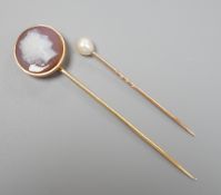 An early 20th century yellow metal and sardonyx cameo set stick pin, carved with the head of a