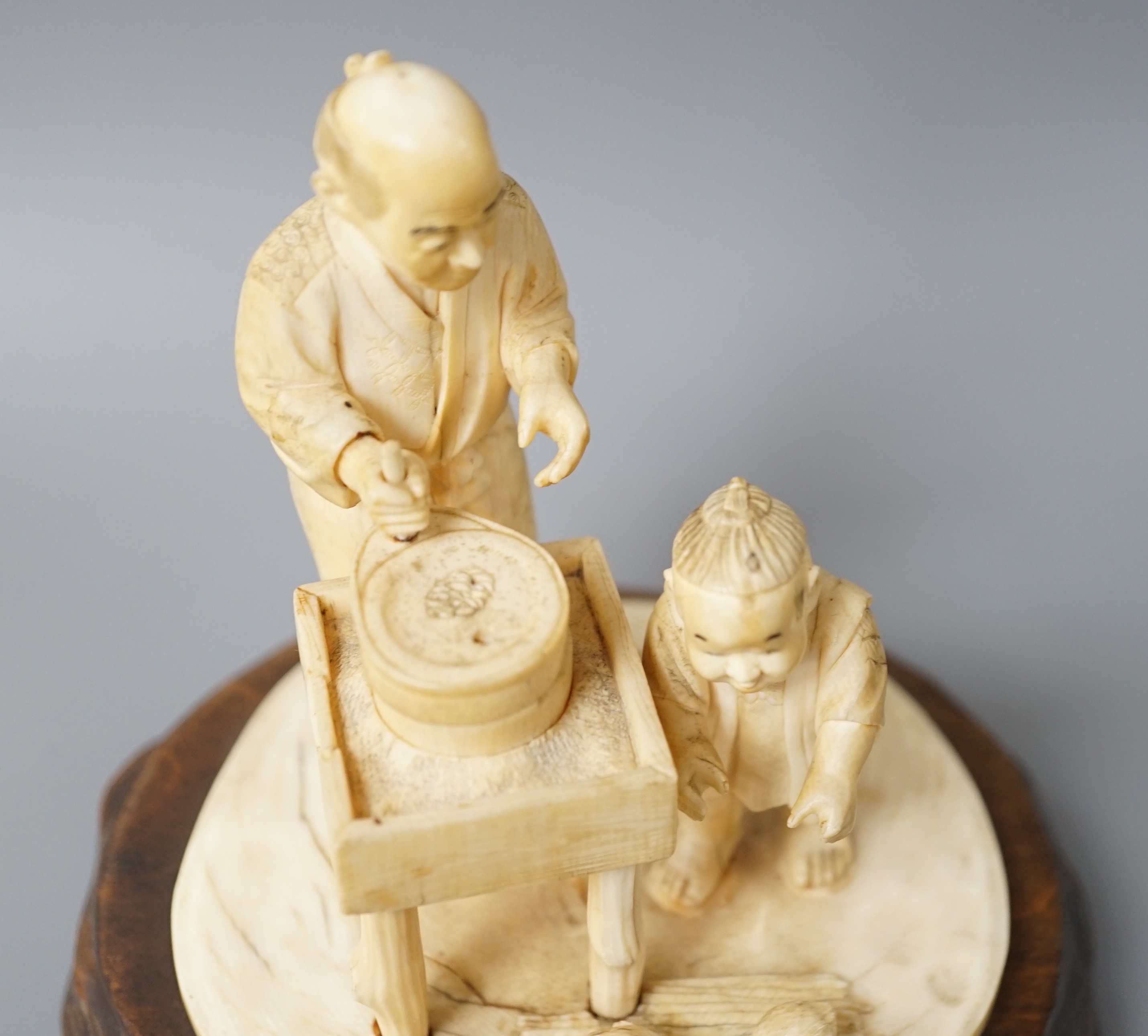 A Japanese ivory okimono of man and boy at a grindstone, Meiji period, signed, wood stand. 15cm - Image 5 of 6