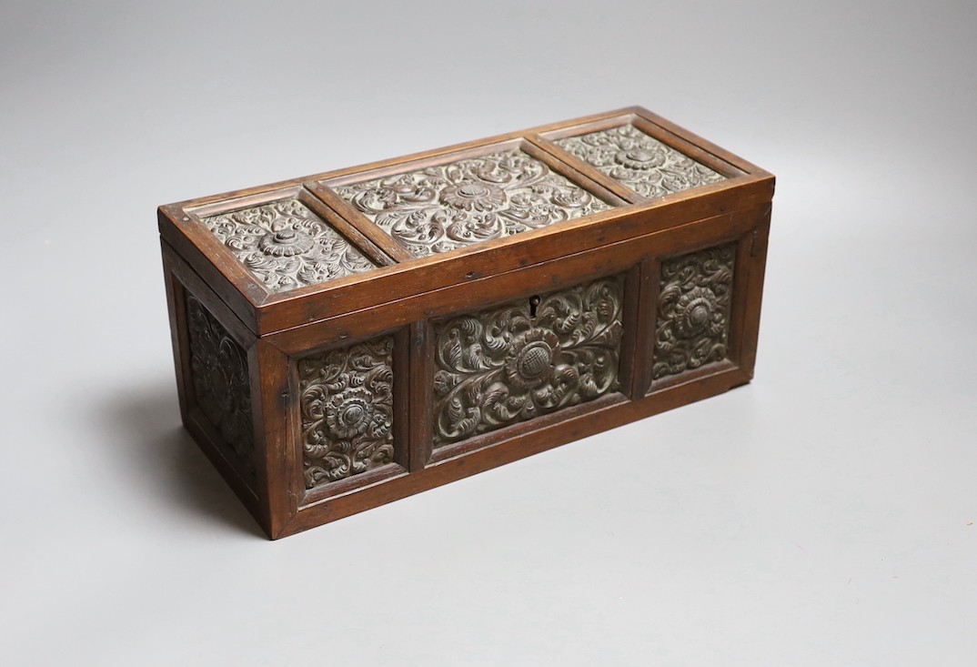 A carved wood panelled box, stamped The Madras School of Art, with label dated 1897, 29cm