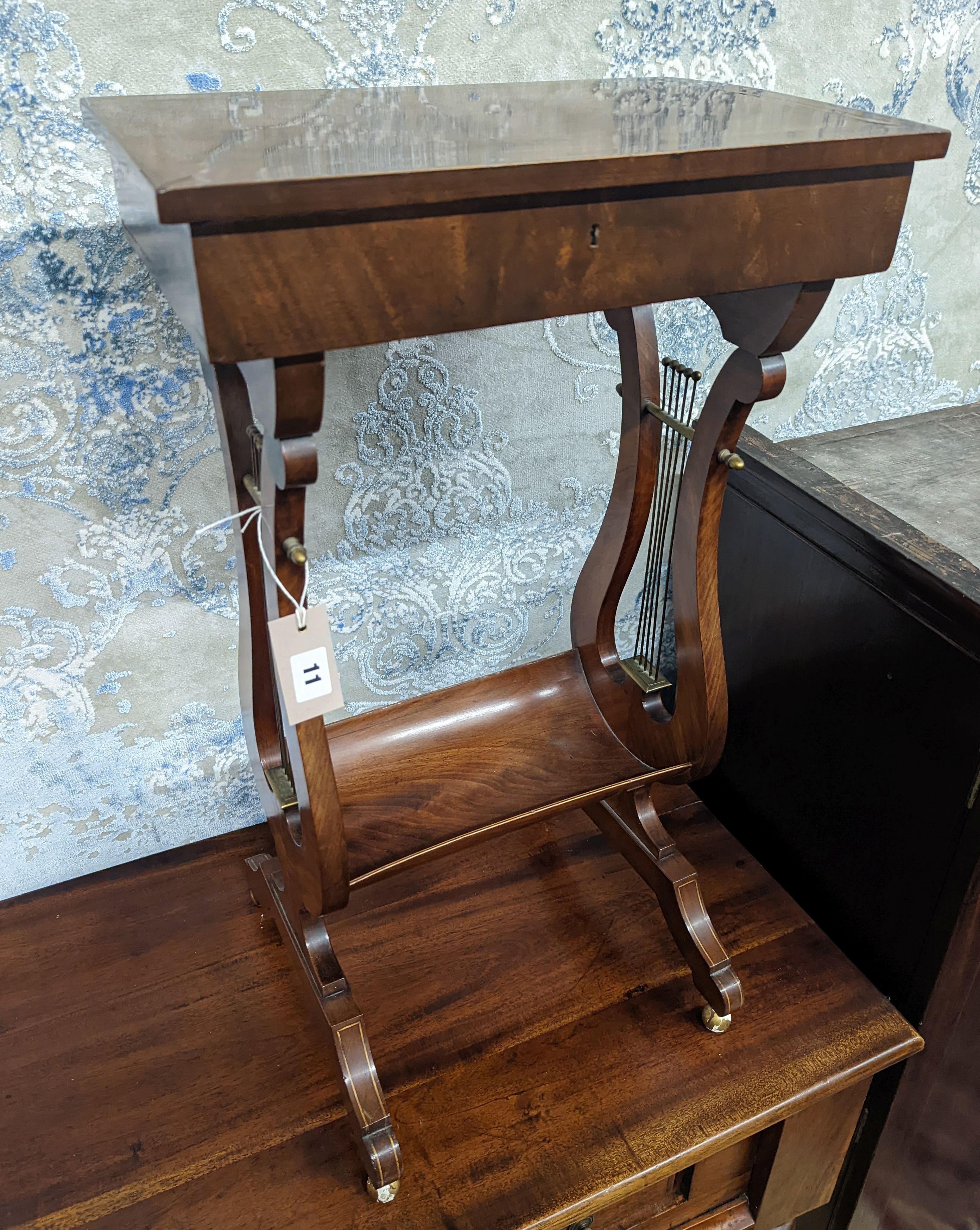 A reproduction Regency style mahogany work table on lyre supports, width 39cm, depth 27cm, height