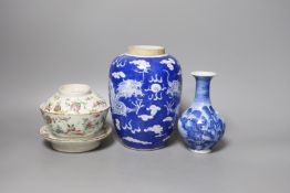 A 19th century Chinese famille rose rice bowl, cover and stand, together with a blue and white