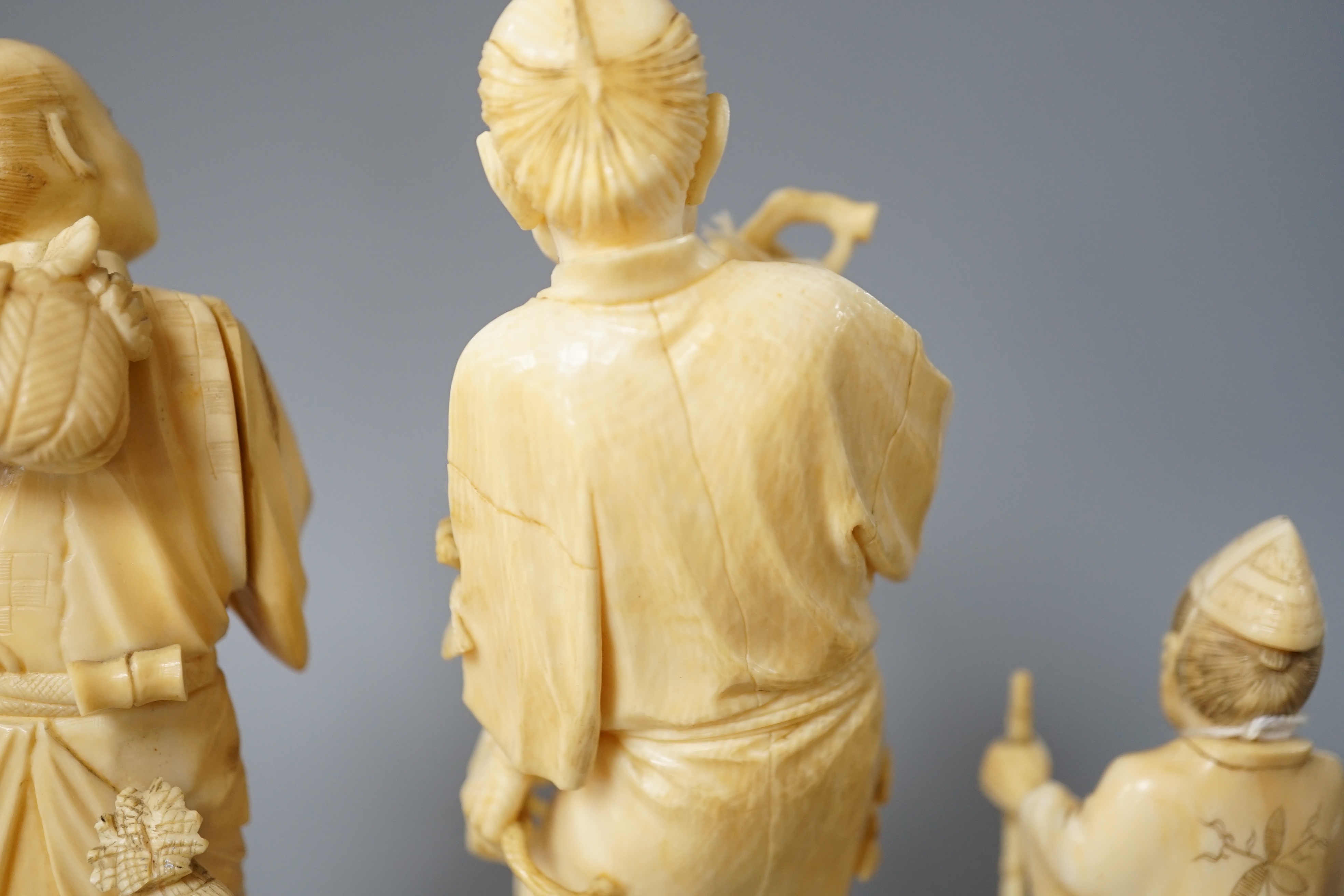 A 19th century Japanese ivory okimono of a gentleman holding a branch, another sectional figure of a - Image 4 of 6