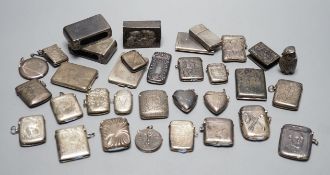 A collection of twenty six assorted mainly early 20th century silver or white metal vesta cases,