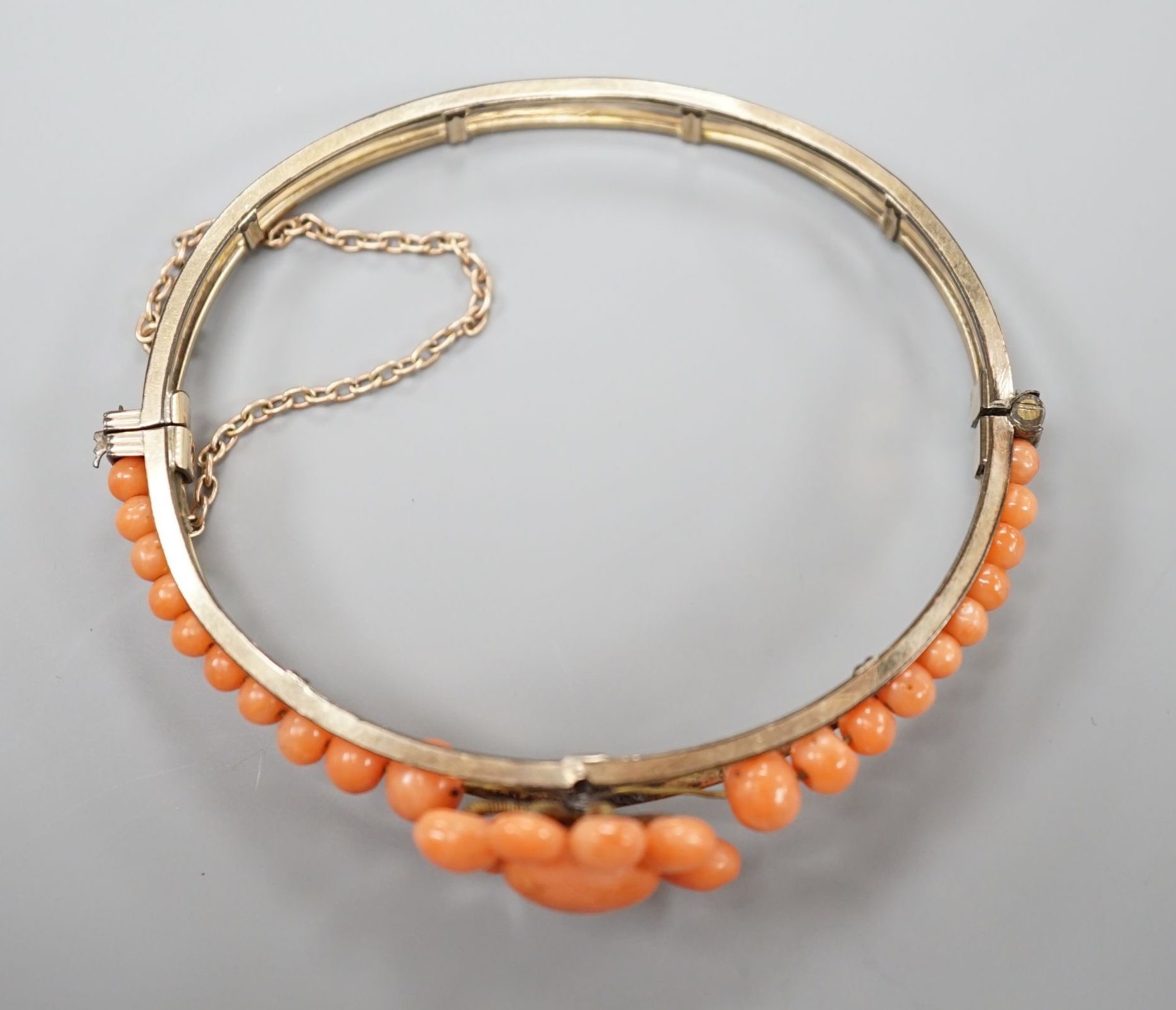 A gold plated and coral bead cluster set hinged bangle. - Image 3 of 3