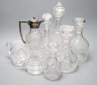 A group of assorted cut glass including decanters, a silver mounted claret jug, two milk jugs,