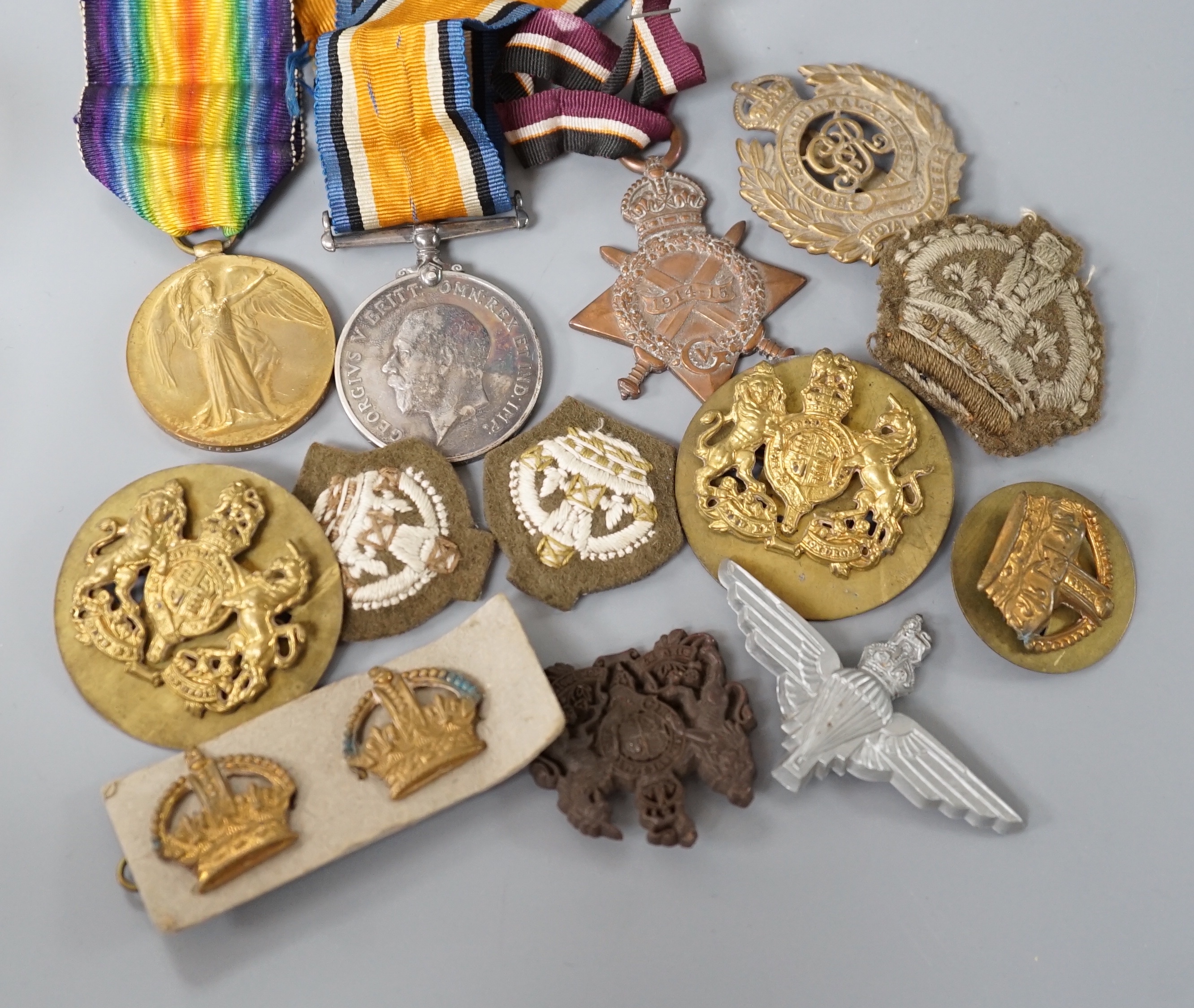 Two WWI medals, collection of cap badges and buttons, Queen Mary tobacco tin and a 66th Infantry