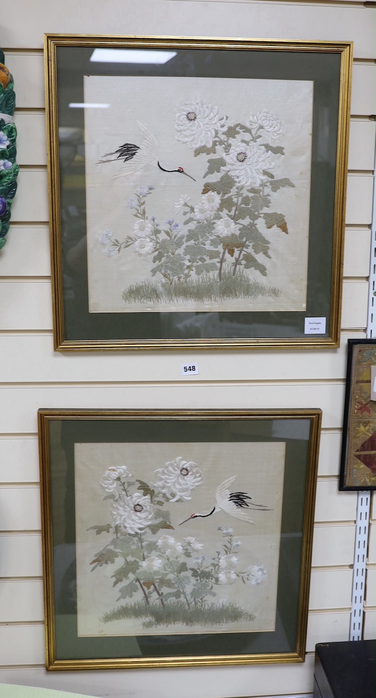 A pair of late 19th century Japanese silk work panels of heron amongst foliage - 41.5 x 41cm