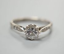 An 18ct and plat, single stone diamond ring, with diamond set shoulders, size O, gross weight 2.9