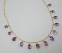 An early 20th century 9ct and graduated oval cut amethyst set drop fringe necklace, 45cm, gross