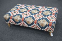 A large contemporary rectangular coffee table / footstool upholstered in Kilim style polychrome