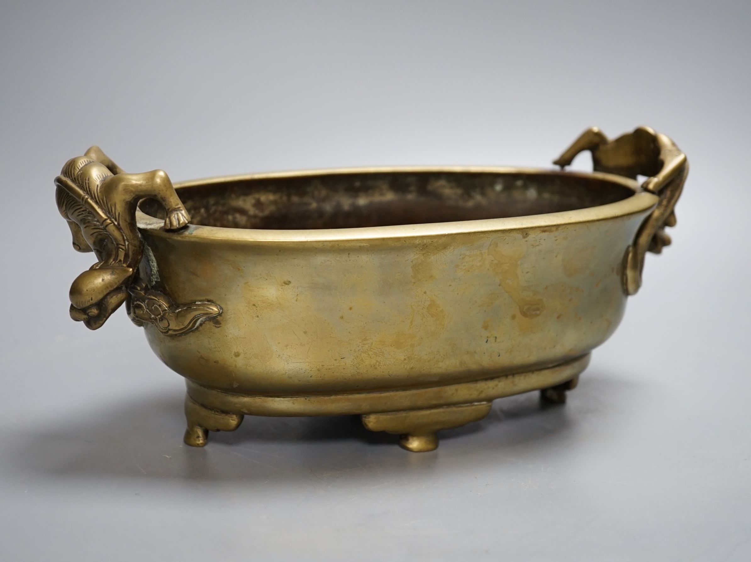 A 19th century Chinese bronze censer with ‘dragon’ handles, Xuande mark, 26cm