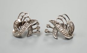 A pair of 20th century white metal and diamond cluster set fan scroll earrings(lacking butterflies),