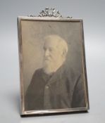 An Edwardian silver mounted photograph frame, with ribbon bow crest, Birmingham, 1902, overall 15.