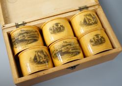 A set of 6 late 19th century mauchline ware napkin rings decorated with scenes of Lewes, housed in