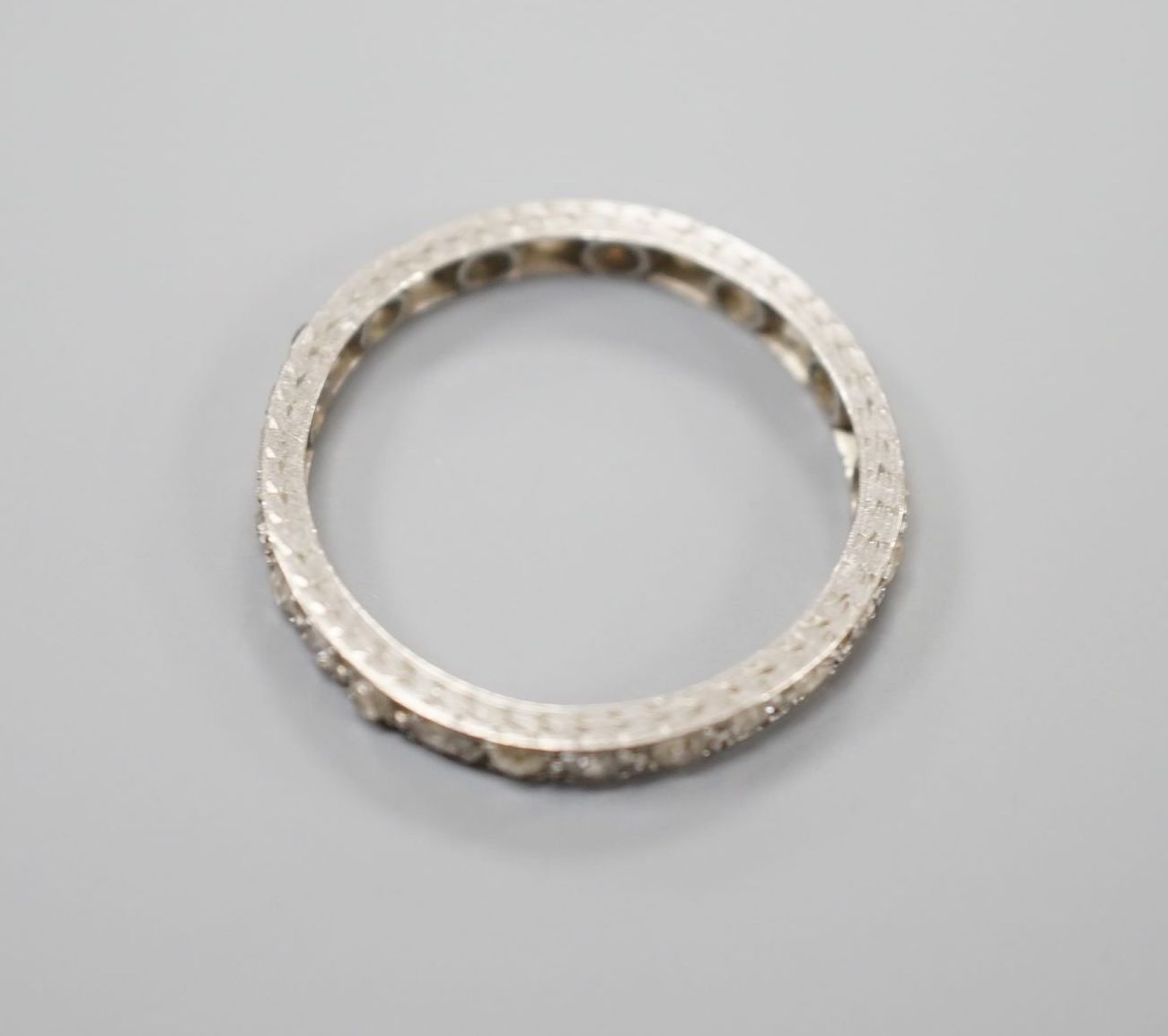 A white metal and diamond chip set full eternity ring, size M, gross weight 2.1 grams. - Image 3 of 3