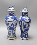 A pair of 19th century Chinese blue and white baluster jars and covers, 27cm