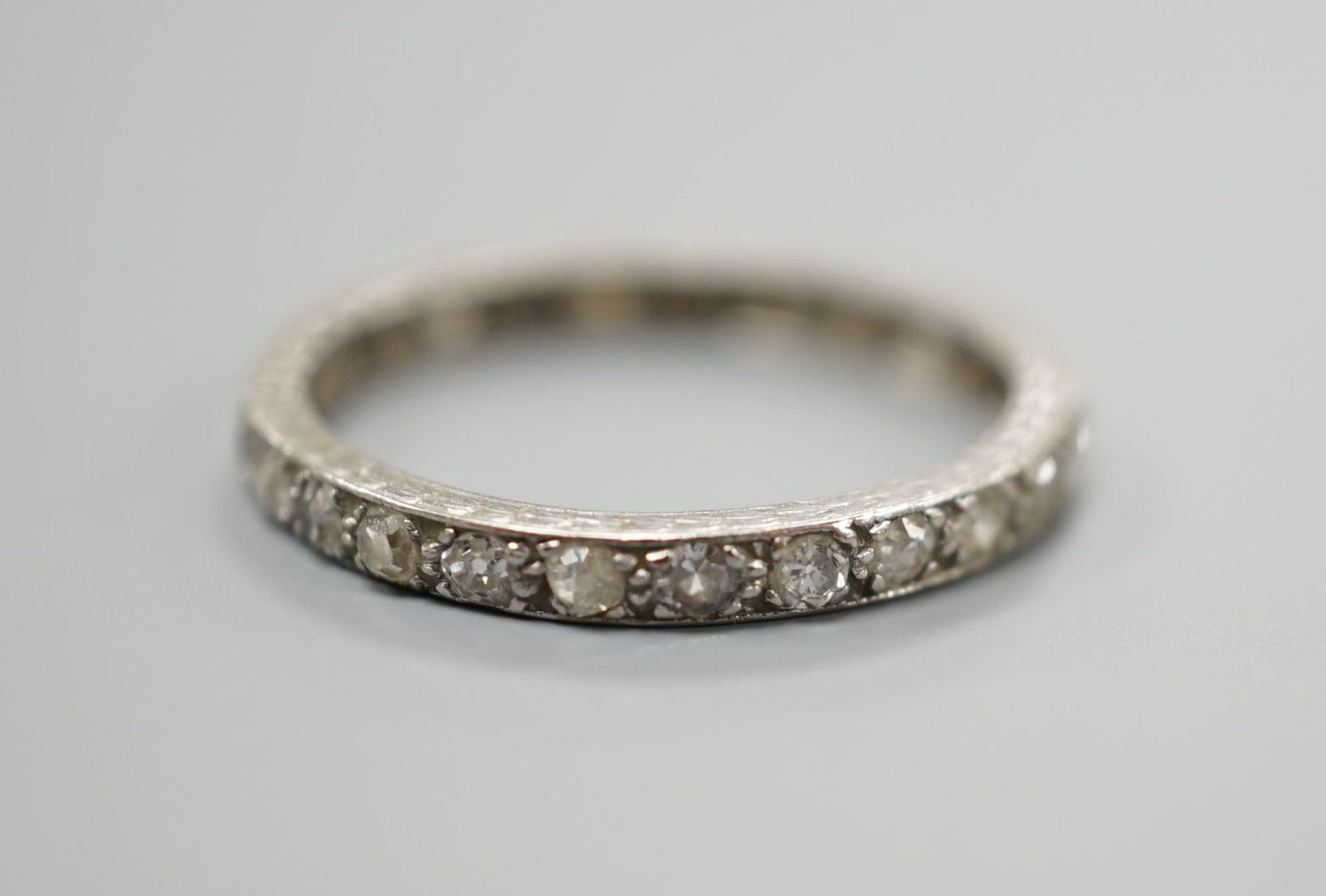 A white metal and diamond chip set full eternity ring, size M, gross weight 2.1 grams. - Image 2 of 3