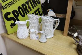 Four Victorian Parian relief-moulded jugs, all battle-related, tallest 24cm