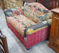 An early 20th century carpet upholstered scroll arm two seater settee, length 150cm, depth 80cm,