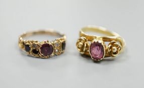 A Victorian gold, garnet and seed pearl set dress ring, size N/O and a yellow metal and garnet set