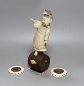 A 19th century Japanese ivory okimono, boy on a barrel with red seal to base, 24cm, together with