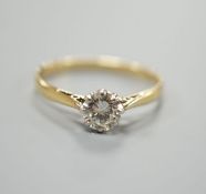 A yellow metal and simulated solitaire diamond ring, size O, gross weight 1.6 grams.