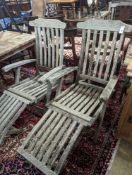 A pair of Indian Ocean teak steamer chairs with footrests, width 63cm, height 100cm