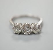 A white metal (stamped Plat) and three stone diamond set ring, size P/Q, gross weight 3.7 grams,