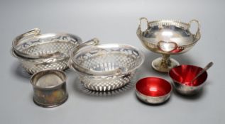 A pair of George V pierced silver bonbon baskets, a small pedestal bowl and napkin ring and two
